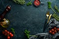Black stone kitchen background. Kitchen board, vegetables and spices on a black background. Royalty Free Stock Photo
