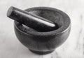 Black Stone Mortar and Pestle on a Marble Countertop Royalty Free Stock Photo