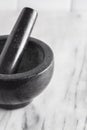 Black Stone Mortar and Pestle on a Marble Countertop Royalty Free Stock Photo