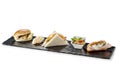 Black stone rectangular tray with snack Pretzel turkey flaky cheese sandwiches salmon pearl spelled vegetables milk sandwiches