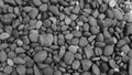 Black stone background. Shiny black lava pebbles on the beach Royalty Free Stock Photo