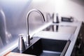 Black stone sink and water faucet in new modern kitchen interior. Royalty Free Stock Photo