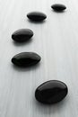 Black stone, zen spa on white wood Royalty Free Stock Photo