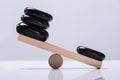 Black Stones Balancing On Seesaw