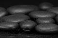 black stones with drops on black background black pebbles Royalty Free Stock Photo