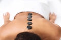 Black stones on naked black lady back Royalty Free Stock Photo