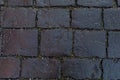 Black stones of an old pavement. Backdrop background texture, square rectangular geometric cobblestones, ice crumb