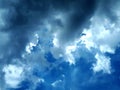 black storm clouds that are forming.  behind the clouds you can see the blue sky Royalty Free Stock Photo