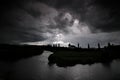 Black storm clouds over a river