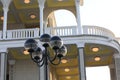 A black street lamp in front of a building with a white Baroque balcony. Royalty Free Stock Photo