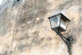 Black street lamp or lantern on the exterior wall facade of house to provide light at the night