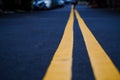 The black street with yellow line, selective focus, blurred back