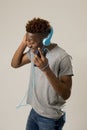 Black student man with headphones and mobile phone listening to music dancing and singing Royalty Free Stock Photo