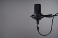 Black studio condenser microphone on grey background, Royalty Free Stock Photo