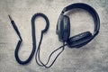 Black studio retro headphones on gray background, professional earphones