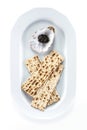 Black sturgeon caviar and matzah on plate, view from above. With