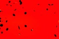 Black stylish falling confetti on red Royalty Free Stock Photo