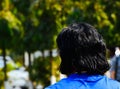 Black stylish hairs of a standing adult man