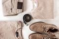 Black stylish leather belt lies next to a knitted sweater with classic trousers with suede boots with a cotton pullover on a white Royalty Free Stock Photo