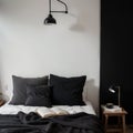 Black stylish loft bedroom Unmade bed with breakfast and reading on tray Lamp and interior decor over blank blackboard wall