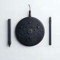 Black stylus and a circular pad with multiple buttons on a white background