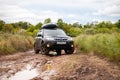 Black Subaru Forester at dirty forest road in summer