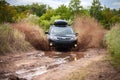 Black Subaru Forester moving at dirty forest road