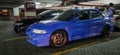 Black Subaru WRX STI and Blue Mitsubishi Lancer Evolution VI in an underground parking lot Royalty Free Stock Photo