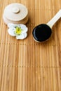 Black substance in wooden jar on a wooden background. Royalty Free Stock Photo