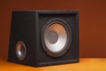 Black subwoofer speaker car audio music system on orange background Royalty Free Stock Photo