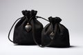 Black suede fabric bags with laces, decorated with stones and amulets for jewelry are on the table