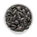 Black sunflower seeds in white bowl isolated on white. Top view Royalty Free Stock Photo