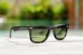 Black sunglasses next to swimming pool Royalty Free Stock Photo