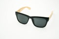 Black sunglasses with wooden legs on white background