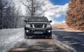 Black off-road truck, two seasons Royalty Free Stock Photo