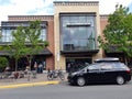 Black SUV parked on a street in front of a modern building