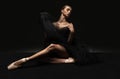 Portrait of young beautiful girl, modern ballet dancers posing on dark background. Feelings, emotions concept