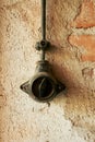 Black switch is hanging from a wall. Vertical background, wallpapers. Royalty Free Stock Photo