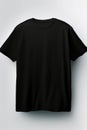 Black t - shirt hanging on wall with white background. Generative AI Royalty Free Stock Photo