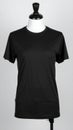 Black T Shirt on a Mannequin in Studio Lighting Against Gray Background Royalty Free Stock Photo