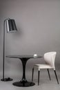 Black table, chair and the floor lamp on gray background. Modern furniture composition for interior.