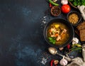 Black table with kvass and ingredients, delicious okra soup with plain navy blue Royalty Free Stock Photo