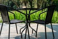 black table on terrace of house. wicker rattan chair on patio ne Royalty Free Stock Photo