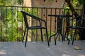 black table on terrace of house. wicker rattan chair on patio ne Royalty Free Stock Photo