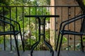 black table on terrace of house. wicker rattan chair on patio ne Royalty Free Stock Photo