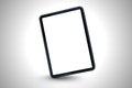 A black tablet with a blank white screen is displayed against a gradient background surface Royalty Free Stock Photo