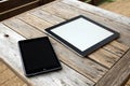Black Tablet PC with Blank Screen on Old Wood Table Royalty Free Stock Photo