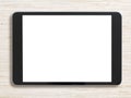 Black tablet pc on bleached wood background