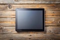 Black tablet PC on old wood table background Royalty Free Stock Photo