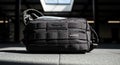 Black Tactical Utility Bag with MOLLE Webbing and TUSTO Patch on Concrete Floor Royalty Free Stock Photo